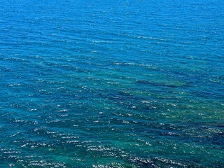 Blue turquoise ocean water twinkling surface.