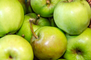Close-up of green apples in a woven wicker basket