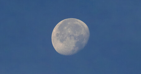 Full moon over blue sky