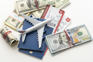 Airplane and money. Plane on the background of USA dollars. The cost of travel, air tickets and flights, financial expenses for vacation.
