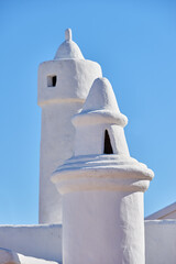 Andalusian architecture, chimney and roof on house outdoor for travel, vacation and tourism at village in Spain. Traditional, ventilation tower and building for history, design and blue sky at home