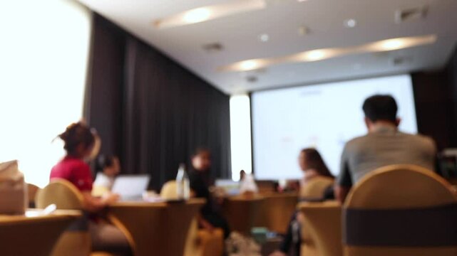 Abstract blured image of business persons meeting in a room.