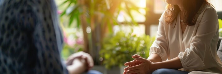 Close-up view of a therapist engaged in a thoughtful discussion with a client in a serene therapy setting during the afternoon