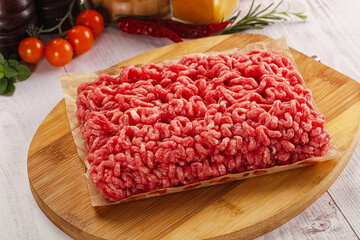 Raw minced beef meat over board