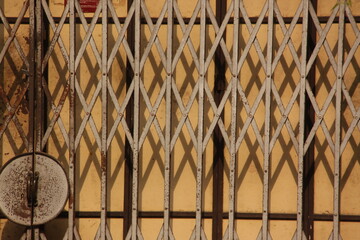  grille door, sliding grille door, vintage style, close up of a metal collapsible sliding grille door normally use at shop houses in Asia, Malaysia, Penang, Georgetown