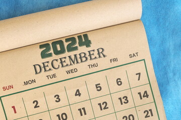 December 2024 calendar flat lay in blue background with copy space.