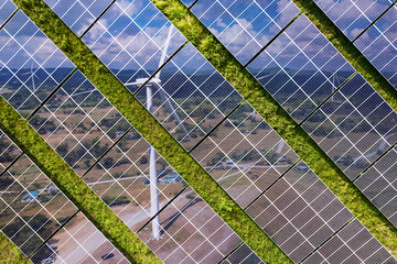 Solar farm superimposed with an image of a wind farm. Symbolizing two in-demand renewable energy...