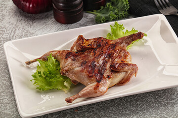 Grilled quail in the plate