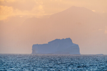 Impression of a giant icebeg illuminated by a beautiful sunset over the Bransfield strait in...