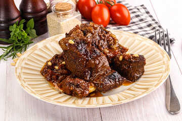 Prepared tasty beef ribs with sauce