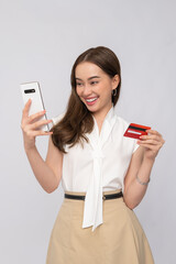 Happy woman making an online purchase with her smartphone and credit card, enjoying the convenience...