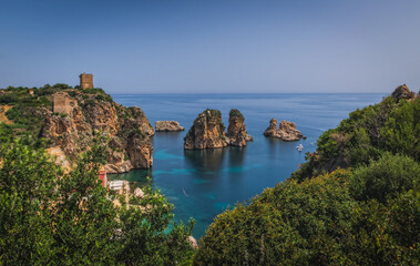 Cliffs on the coast in summer in Scopello near of Castellammare del Golfo in Sicily, Italy. June 2023, long exposure picture, sunrise time.