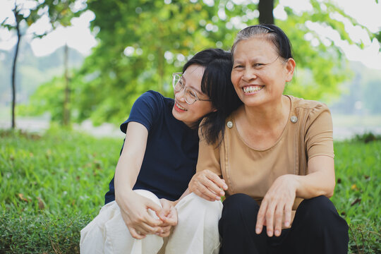 Young Asian woman with her mother in the park