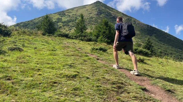 Young Hiker Walks Up in High Carpathian Mountains