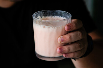 A glass containing strawberry yogurt.