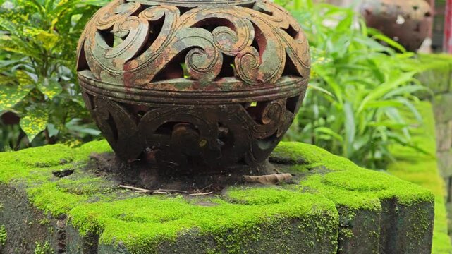 Clay pot on brick covered by moss.
