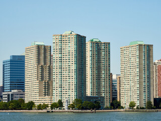 Obraz premium View of New Jersey from New York. Jersey City. Waterfront. Liberty Towers. New Port buildings. Path Hoboken station. Statue Cruises Departure.