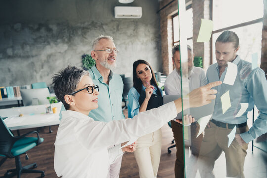 Photo of teamwork people work together business plan brainstorming sticky notes comfortable office loft room interior indoors workspace