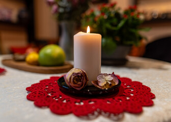 still life with white candle, dry flowers, fruits and other objects