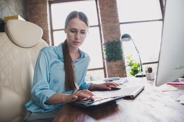 Photo of cheerful positive lady accontant dressed shirt working modern device counting calculator...