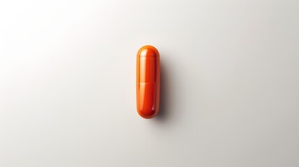 A white pill with orange specks isolated on white background