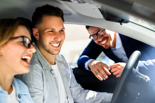 Professional Car Salesman Excitedly Showcases Sleek New Vehicle