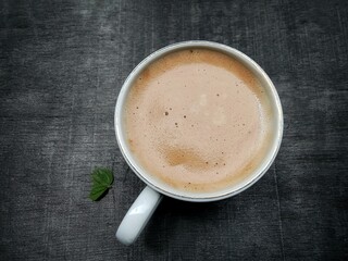 A cup of warm capuccino coffee. very delicious, flat lay.