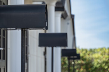 住宅の前に並ぶ黒い複数のポスト