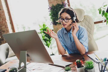 Photo of cheerful positive lady recruiter dressed shirt glasses headphones speeking modern device...