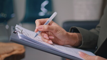 Clinic patient hands writing medical documents in modern office closeup. 