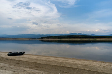 Calm water on a dam and a boat ready for fishing