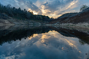 Calm water reflecting a gloomy sky