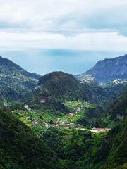 Fototapeta premium Hiking mountain trail among rocks and plants with a view of the clouds and gorge