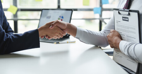 The Human Resources Manager shakes hands with people interested in applying for job vacancies good...