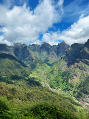 Fototapeta premium Hiking mountain trail among rocks and plants with a view of the clouds and gorge