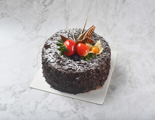 premium freshly baked dark cocoa chocolate brownie black forest blueberry jam round birthday cream cake with strawberry fruits on white marble halal food sweet vegan dessert menu for pastry cafe shop