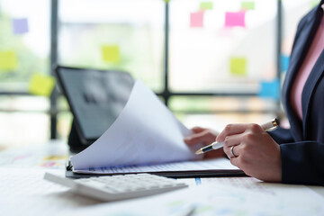 Accountants and marketers use calculators and laptop computers to calculate financial budgets,...