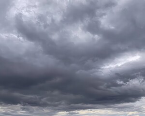 Fototapeta premium Dramatic stormy sky filled with dark clouds, creating a moody atmosphere perfect for weather-themed projects.