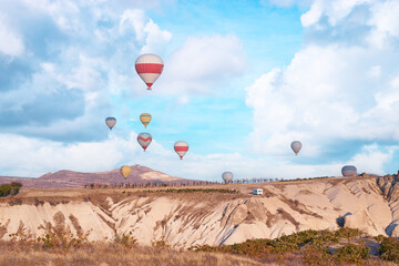 Travel and tourism by Turkey. Famous sightseeing Cappadocia, Anatolia. Beautiful landscape with mountains, caves and baloons in the sky.