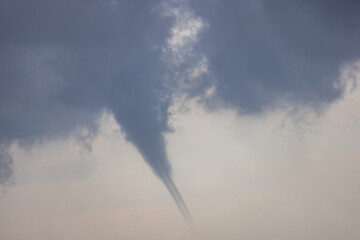 Waterspout in the air above the sea