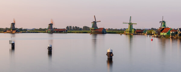 Long exposure panorama of Dutch windmills along the Zaanse Schans in Zaandijk, Netherlands