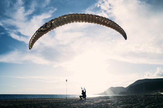 Paragliding on the beach, leisure activity.