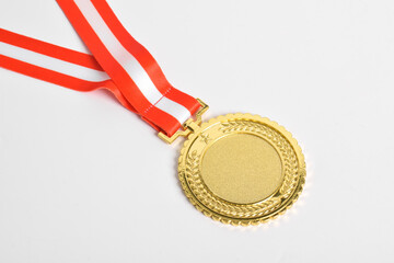 Gold medal with red and white ribbon isolated on white background. First place winner athlete....