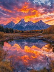 Obraz premium Majestic Mountain Range Reflected in Still Water at Sunset