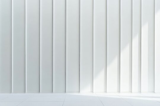 This image depicts a pristine white wall characterized by a series of vertical panels, providing a modern and minimalist aesthetic with sunlight casting shadows on the surface.