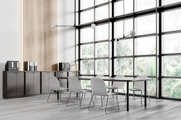 Empty office interior with modern design featuring large windows, sleek furniture, and a light wood floor. Concept of a contemporary workspace. 3D Rendering