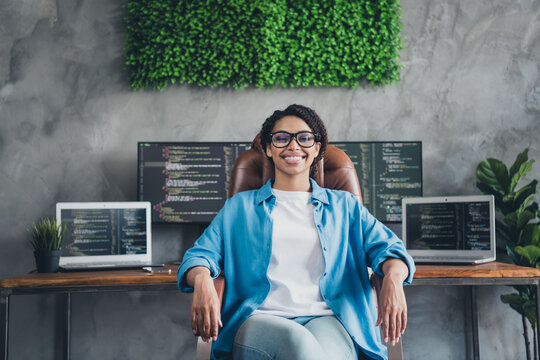 Photo of attractive young woman sit armchair confident boss wear blue shirt modern office programmer loft room interior indoors workspace