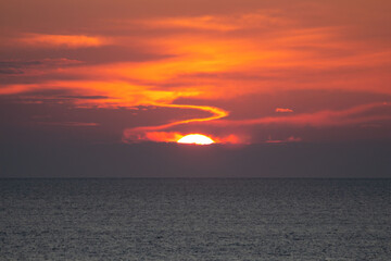 Landscape with sun, sea and red clouds 