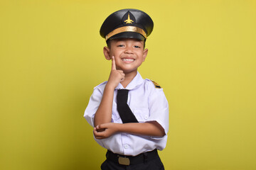 Little Asian boy Airplane pilot isolated on yellow background with cute pose and smile. Little boy dreams of becoming an airplane pilot.