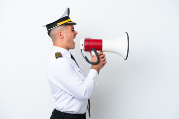 Airplane pilot caucasian man isolated on white background shouting through a megaphone © luismolinero